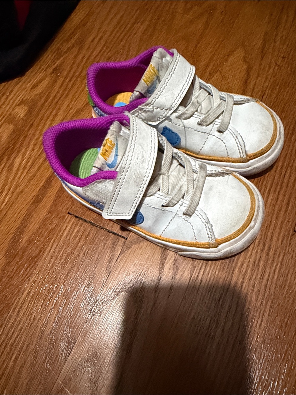 Nike Kids White Sneakers with Purple Lining and Yellow Accents